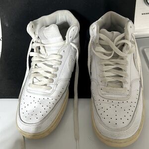 Nike high tops. Men size 8.5. White with some blue stains. Some yellowing bottom